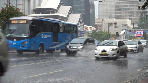 Traffic drives in flash flooded streets Jakarta, monsoon rains Southeast Asia Stock-Footage 78439468