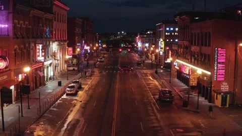 Traffic drives through Lower Broadway in Nashville at night. Aerial view. Stock Footage 159784132