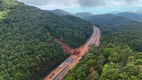 Traffic drives through mudslide during Hurricane Helene in Swannanoa, NC. Stock Footage 299828281
