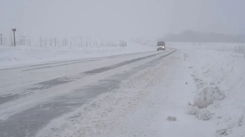 Traffic driving along freeway during intense snow storm Stock Footage 70722953