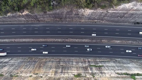 Traffic driving on a highway between two cliffs, Sydney, Australia Stock Footage 122291126