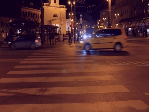 Traffic driving through road zebra crossing at night. Stock Footage 79990433