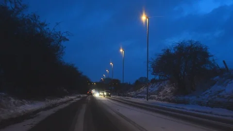 Traffic driving through winter blizzard conditions leeds united kingdom Stock Footage 87829683