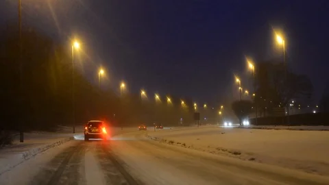Traffic driving through winter blizzard conditions leeds united kingdom Stock Footage 87829689