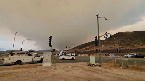 Traffic during a forrest fire and the smoke in the background Stock Footage 225414414