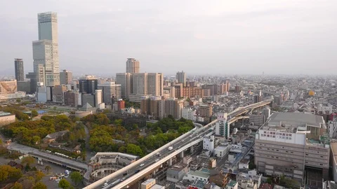 Traffic on elevated roadway and green park of Osaka City Museum of Fine Arts Stock Footage 90377987