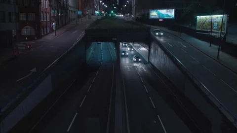 Traffic emerging from underpass at night, UK 2K PRORES 스톡 동영상 153522453