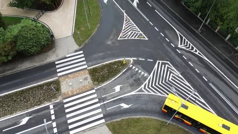 Traffic Flow at a Busy Urban Intersection With a Yellow Bus on a Clear Day Stock Footage 280886746