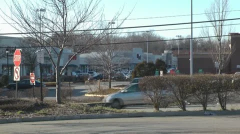 Traffic flow outside strip mall Stock Footage 10605216