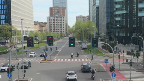 Traffic flow through signalized intersection in Milan city district Stock Footage 338243558