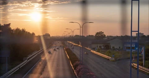 Traffic flow with a wire fence in the foreground Stock Footage 137821413