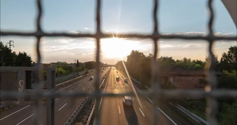 Traffic flow with a wire fence in the foreground Stock Footage 137821640
