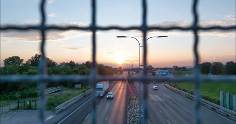 Traffic flow with a wire fence in the foreground. Stock Footage 137822246