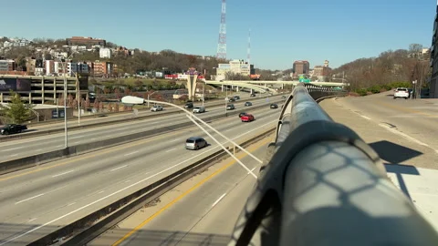 Traffic flowing uphill alongside a guard rail Stock Footage 256950719