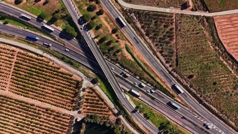 Traffic flows on highways in Spain with fields and hills nearby Stock Footage 327645108