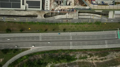 Traffic flows smoothly along the highway near urban development Stock Footage 311987079