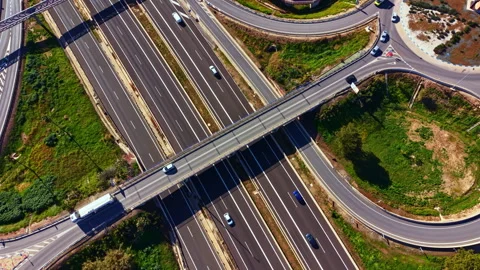 Traffic flows smoothly on a busy highway interchange in a suburban area during Video stock 335362010