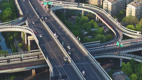 Traffic flows smoothly over a modern interconnected highway system in an urban Stock Footage 308514072