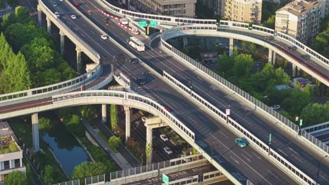 Traffic flows smoothly over a modern interconnected highway system in an urban Stock-Footage 309084870