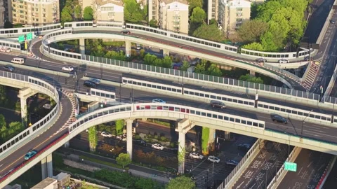 Traffic flows smoothly over a modern interconnected highway system in an urban Video stock 313325175