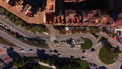 Traffic flows through roundabout in a busy area of Spain during the day Stock Footage 327647298