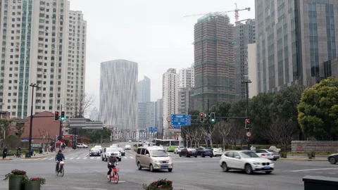 Traffic flows through a Shanghai intersection flanked by high-rise residential Stockbeeldmateriaal 330977485