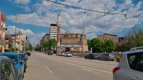Traffic flows through Sofia’s Serdika district with the Banya Bashi Mosque and Stock Footage 312056831