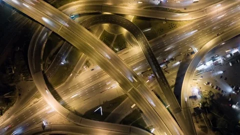 Traffic on freeway interchange. Aerial night view timelapse city traffic Video stock 80351454