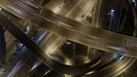 Traffic on freeway interchange. Aerial night view timelapse city traffic. Video stock 80448064