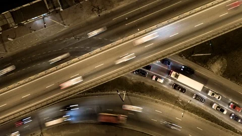 Traffic on freeway interchange. Aerial night view timelapse city traffic. UHD Stock Footage 105876748