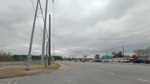 Traffic on Gordon Highway on a cloudy day in Augusta Georgia close up Stock Footage 148895600