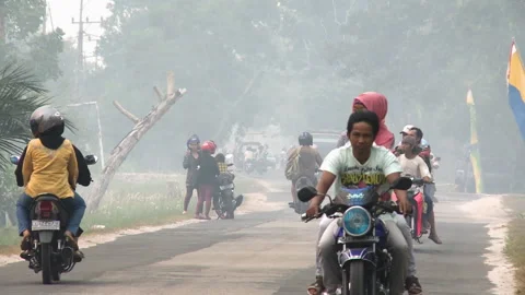 Traffic in Haze during Peat Fires, Indonesia Stock Footage 142850270