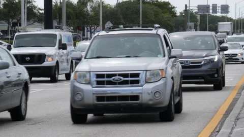 Traffic Heads Eastbound on Sample Road from Military Trail Stock Footage 200853467