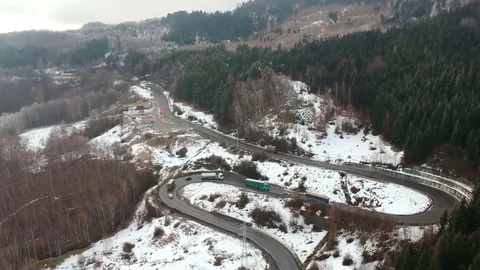 Traffic on high mountain pass road in winter , aerial view Video stock 103403411