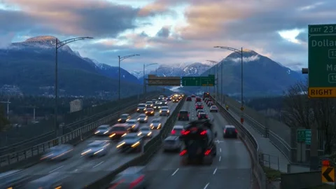 Traffic on the highway against the backdrop of a mountain range. Travel. 4K Stock Footage 220923530