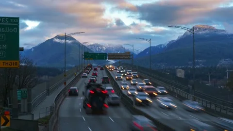 Traffic on the highway against the backdrop of a mountain range. Freeway. 4K Stock Footage 220923545
