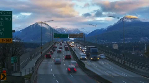 Traffic on the highway against the backdrop of a mountain range. Freeway. 4K Stock Footage 220923568