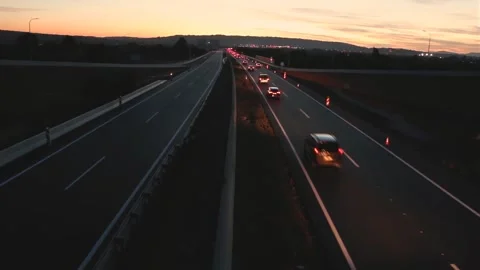 Traffic on a highway at dusk only in one way with no traffic the other way Stock Footage 259647829