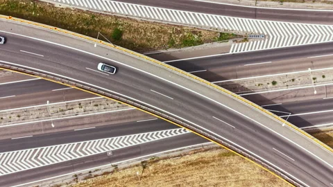Traffic on a highway interchange during the day in an open landscape Stock Footage 344172004