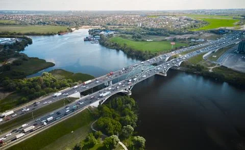 Traffic on highway over river. Two bridges and water. Double-sided motion. Stock Photos