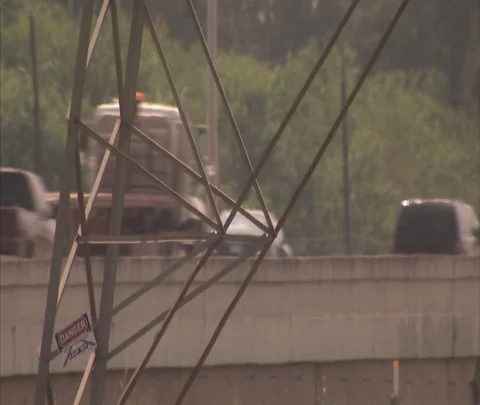 Traffic on highway seen through high voltage wires Stock Footage 86806712