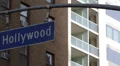 Traffic Hollywood Street Boulevard Sign Brown White Apartments Flat Buildings HD Footage