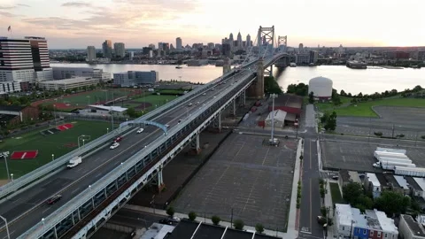Traffic on iconic benjamin Franklin’s bridge in Camden at sunset. Crossing Stock Footage 315289914