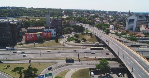 Traffic interchange, camera flies paralel with road. Construction ground. 스톡 동영상 97065112