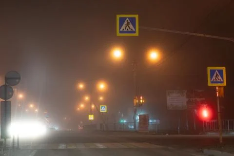 Traffic at an intersection in the fog Stock Photos