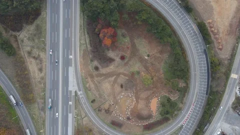 Traffic intersection in the form of loop and trees suburb aerial view. Stock Footage 165664466