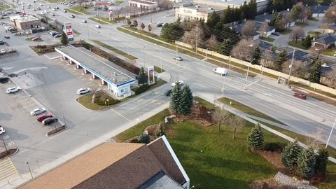 Traffic By Intersection Of Gas Station And Other Buildings Stock-Footage 121199523