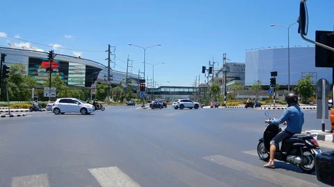 Traffic at intersection infront of central phuket department store Stock Footage 128273406