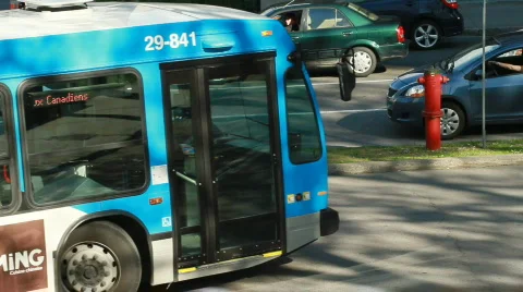 Traffic at intersection as man waits to cross Stock Footage 704514