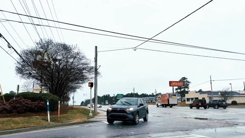 Traffic at an intersection on a rainy day in the Winter in Georgia Stock Footage 147097046